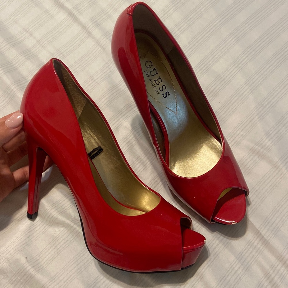 Red , Guess, high heels. Stilettos, bright red with gold inner lining, shiny.